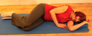 side-lying with knees bent in front at start of clam exercise