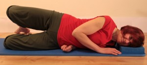 side-lying with feet behind and top knee open for clam