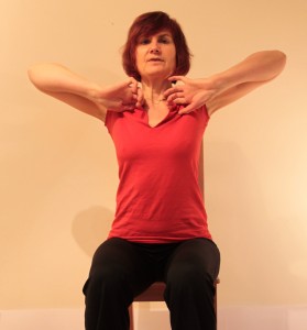 Sitting with elbows at sides making circles from front to back