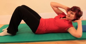 hands to head, reaching elbow to opposite knee for obliques strengthener