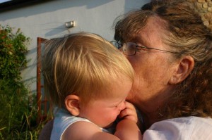 Meg cuddles sleeping grandchild